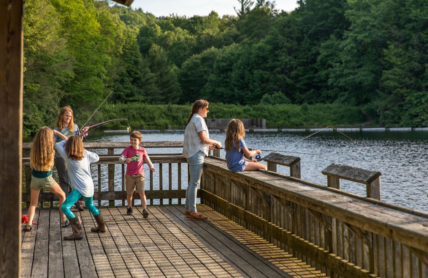 Photo of a family fishing at the lake with Zebco reels