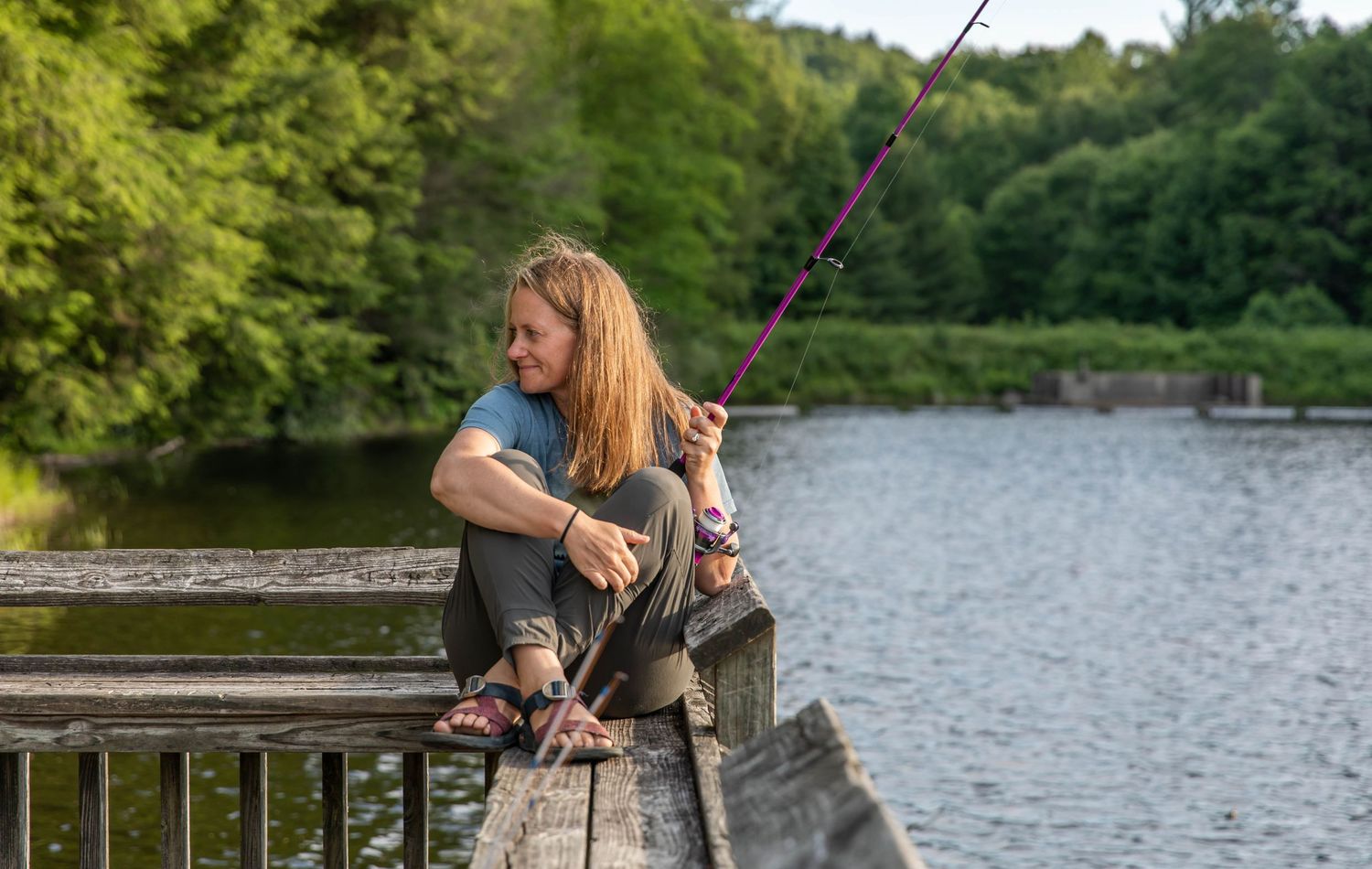 Photo of woman fishing at the lake with Zebco reel
