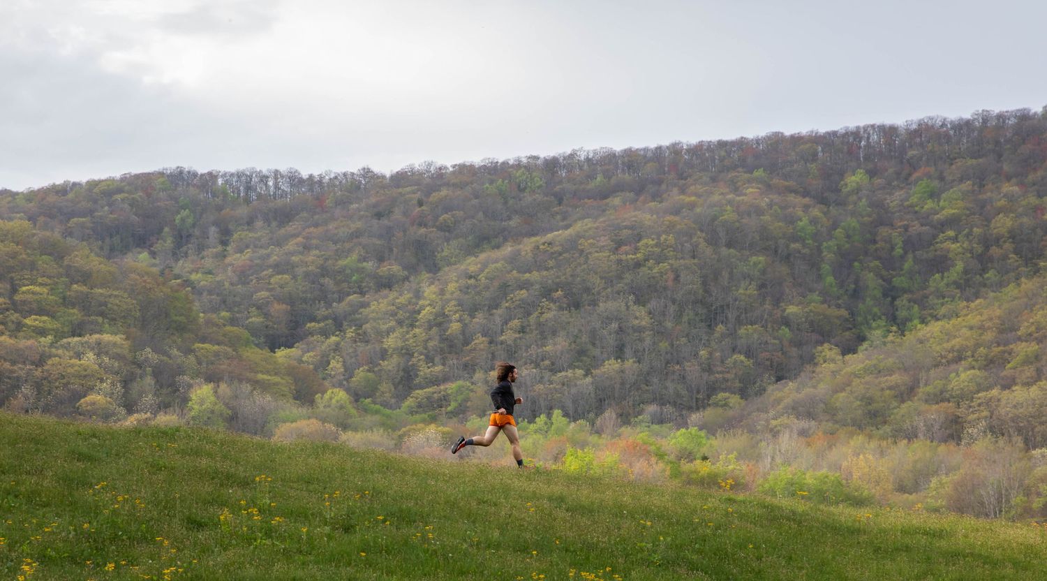 Photo of a man running in front of mountain in southwest Virginia wearing Run Strong socks from Fox River Mills