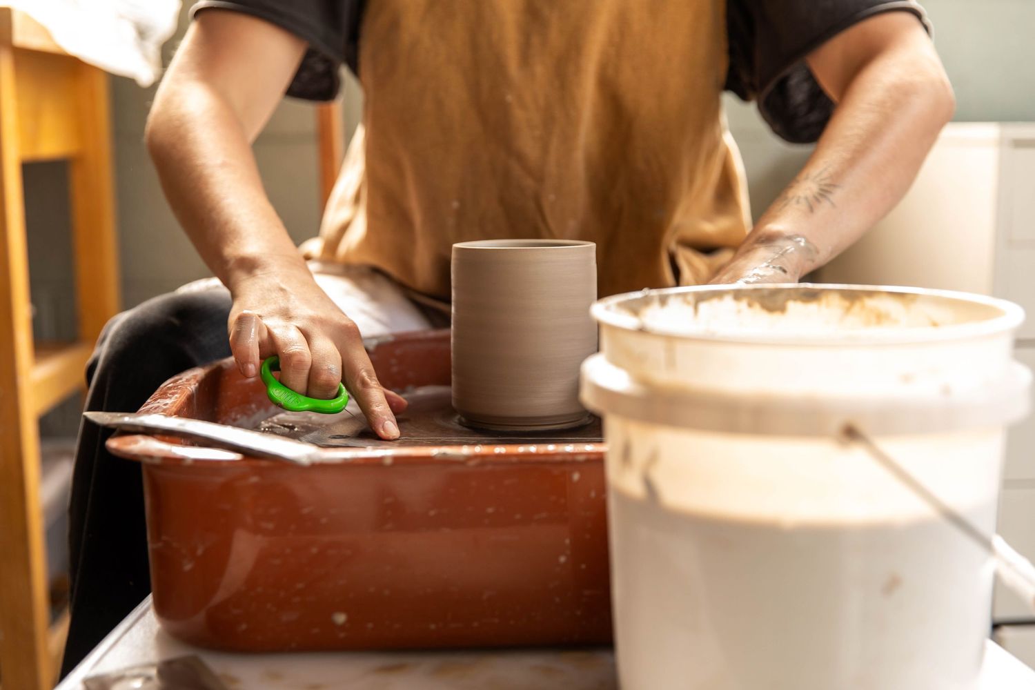 Photo of a potter at work at her wheel in Boone, NC