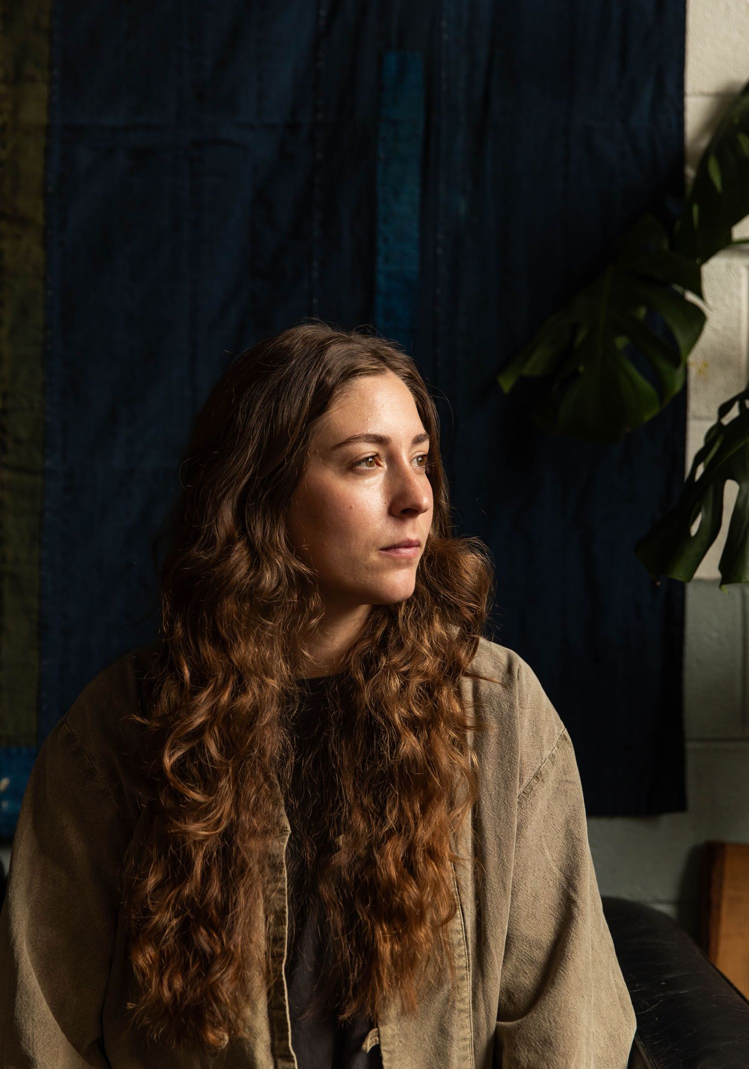 Portrait of a woman in window light during sunset in her pottery studio