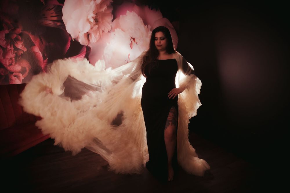 A silhouetted figure stands against a dramatic backdrop of swirling smoke and red lighting effects.