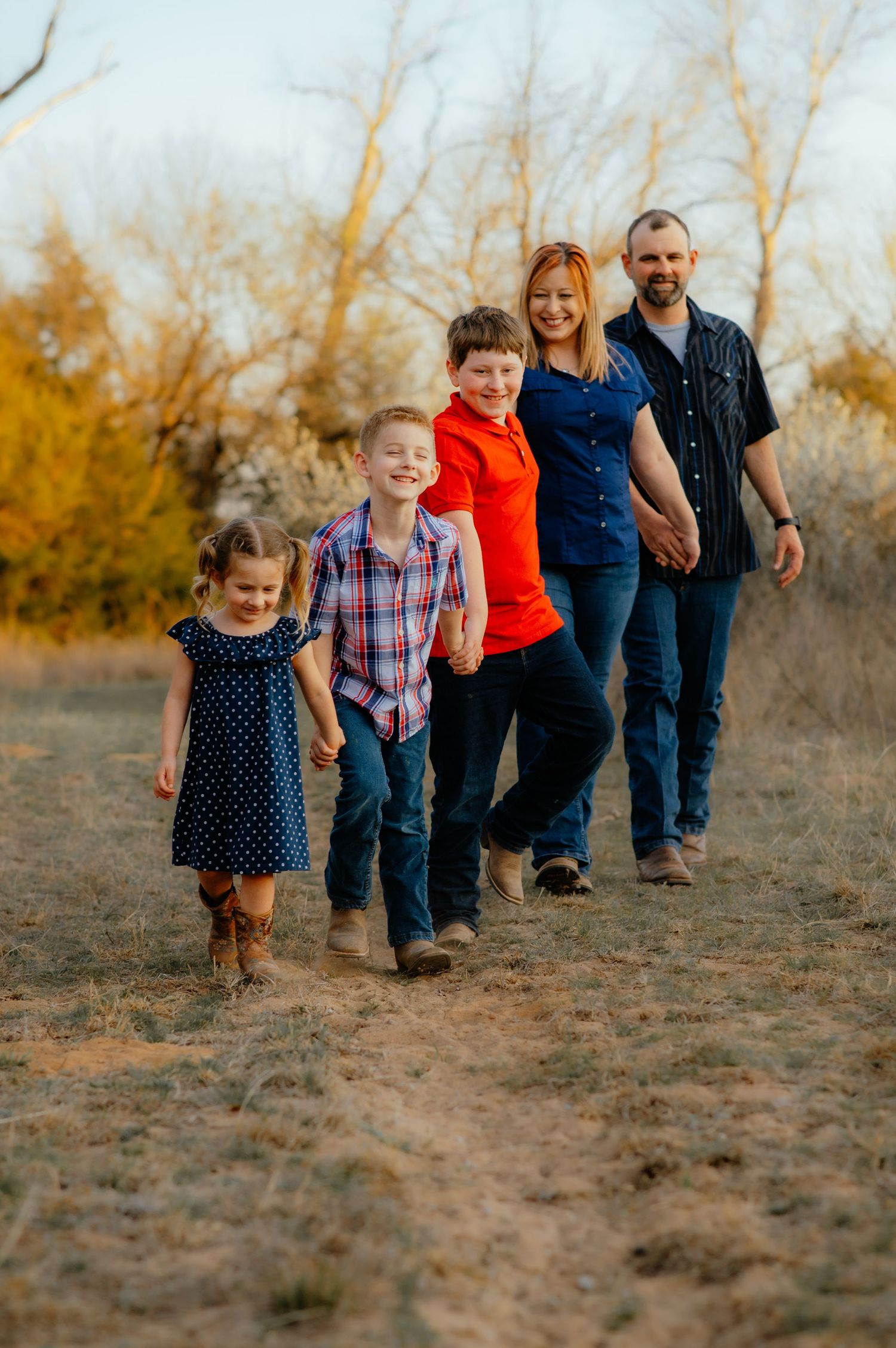Family of 5 walking hand in hand during a photo session with a family photographer in Enid OK.