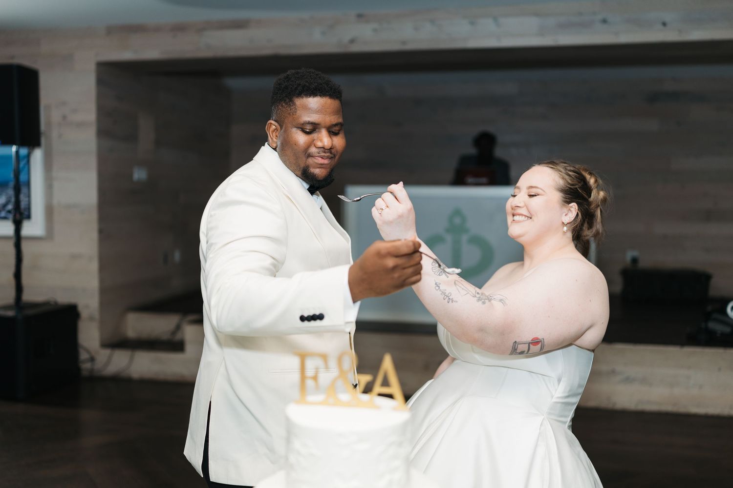 Happy couple shares an intimate moment while dancing and smiling at their wedding celebration.