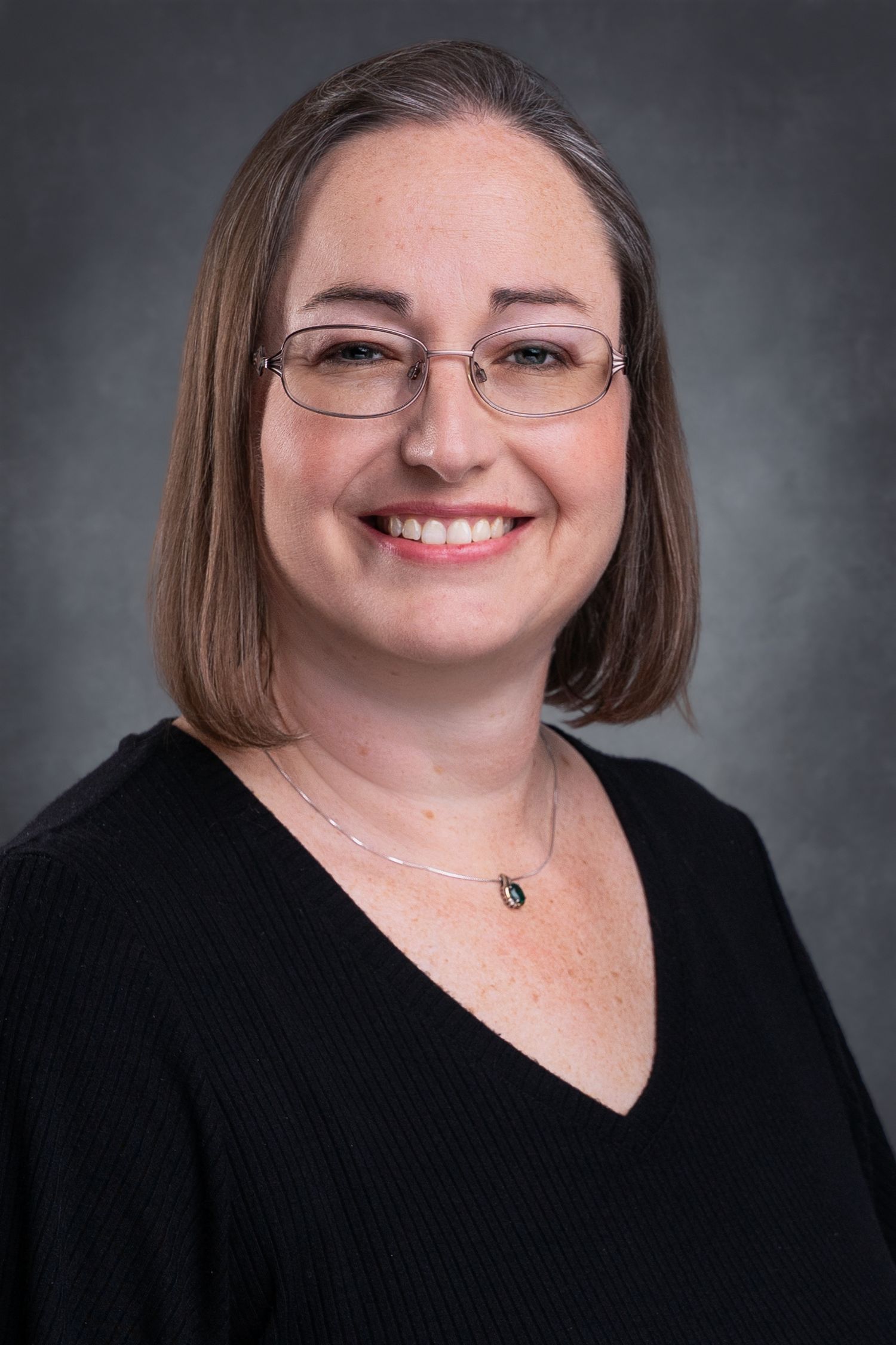 Studio headshot of an East Tennessee realtor wearing a black sweater taken by Dandridge headshot and personal branding photographer
