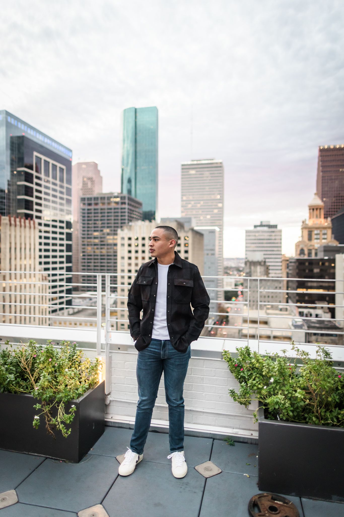 Modern rooftop fashion portrait with Houston city skyline backdrop.