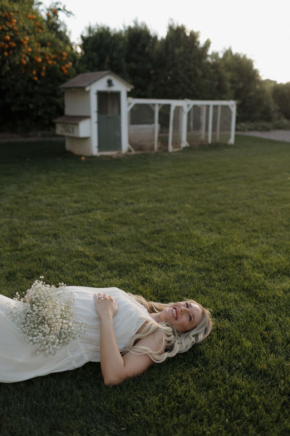 Ethereal outdoor photography with baby's breath flowers on green grass near white vintage mailboxes.