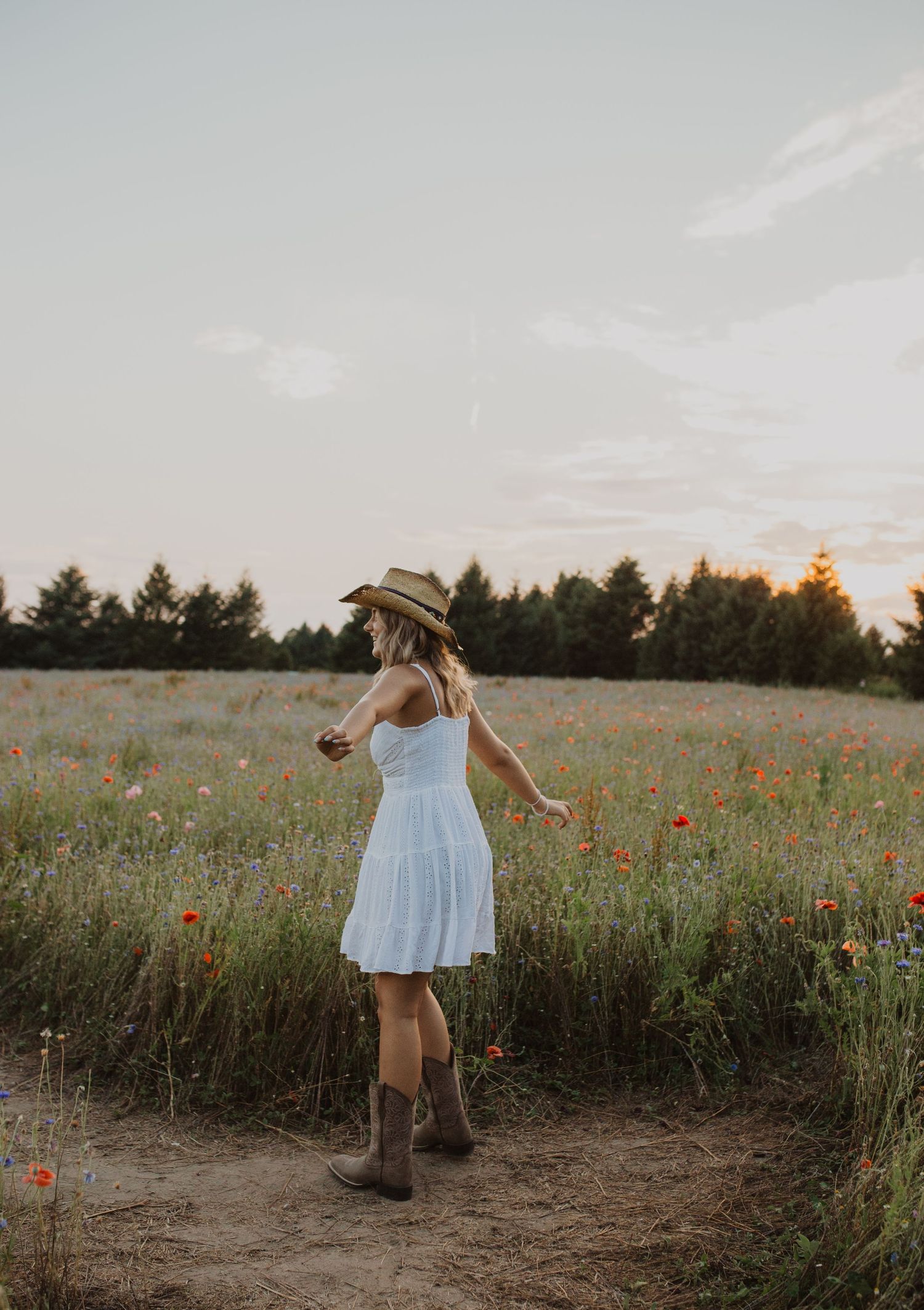 Carefree moment captured in a wildflower field during sunset.