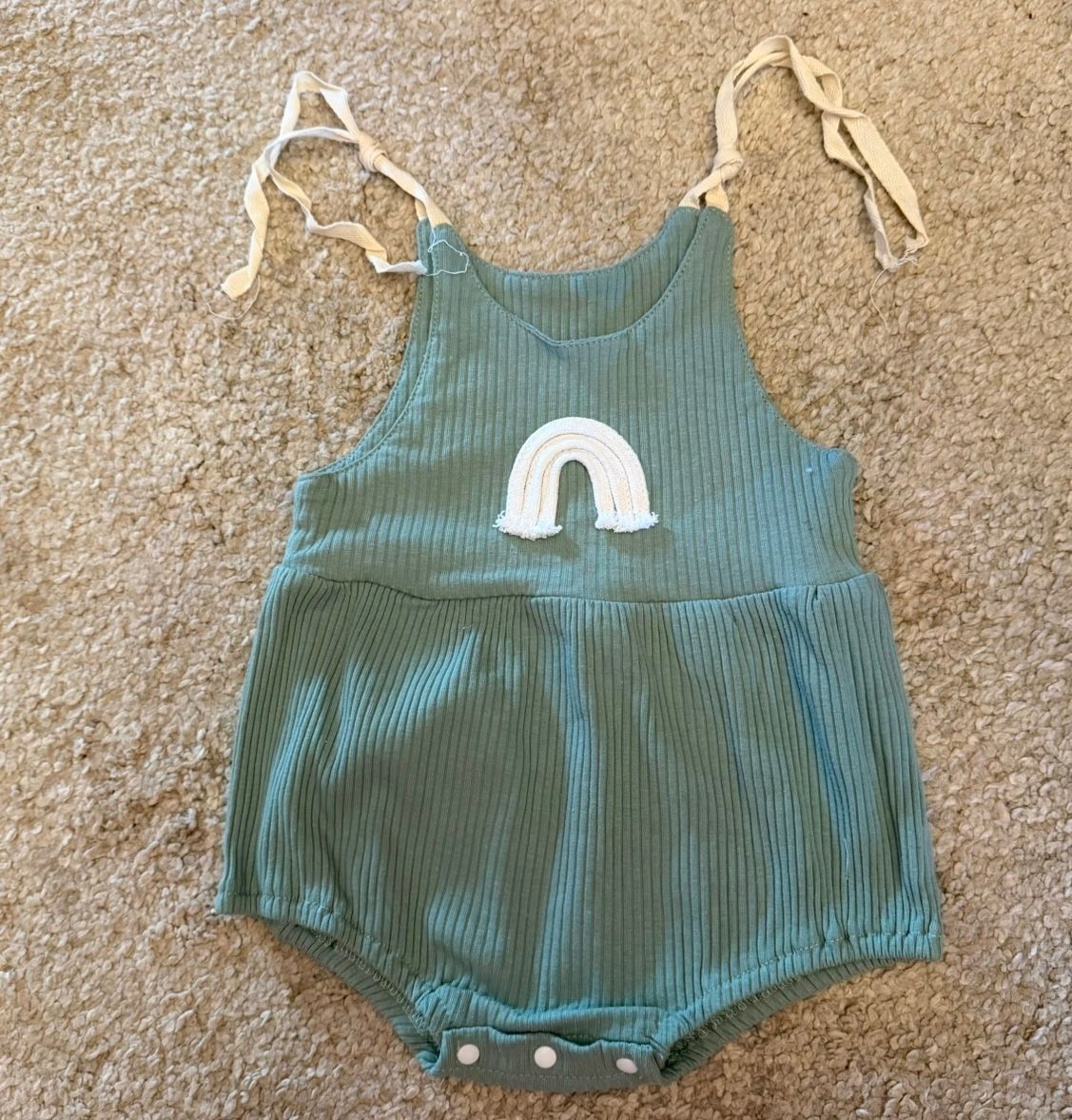 Teal ribbed baby romper with white applique detail.