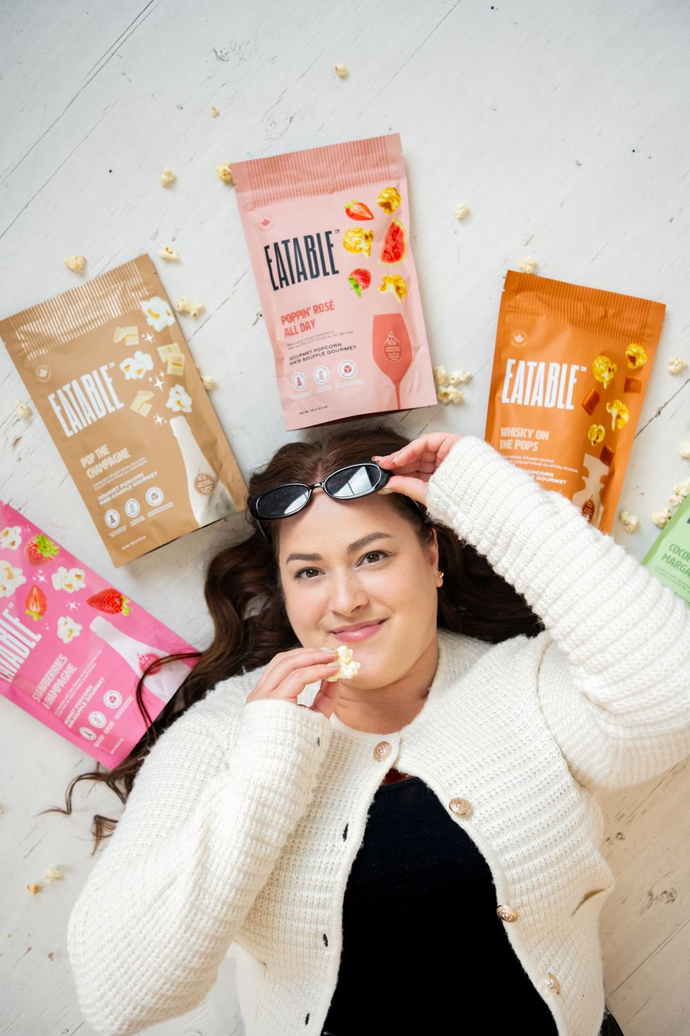 Colorful snack food packages arranged artistically on a white surface with lifestyle product photography.