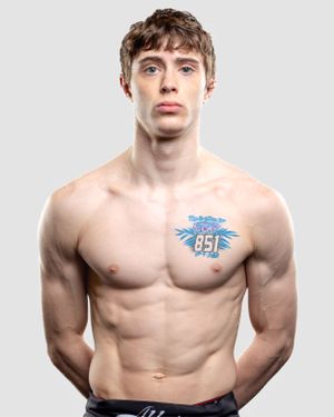 Athletic person with muscular upper body showing torso with blue winged number 85 temporary tattoo on chest.