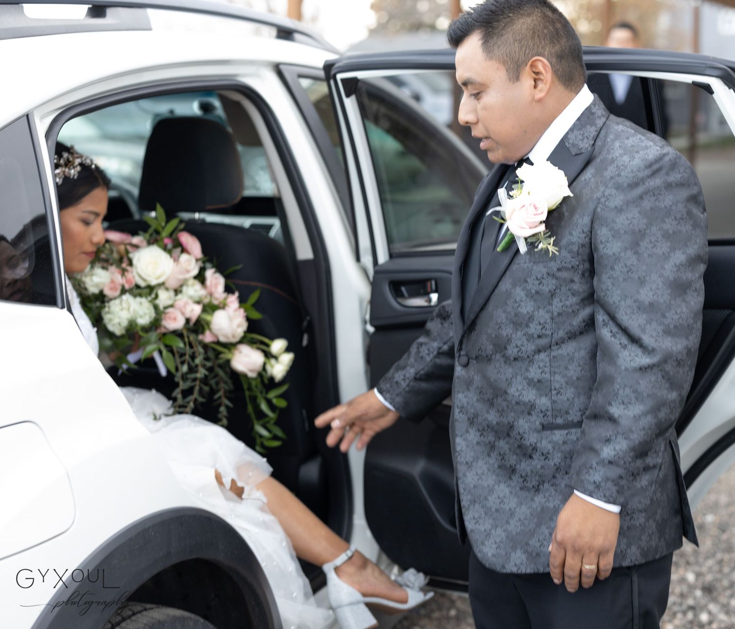 Wedding party arriving in elegant car with beautiful floral bouquet on a special day.