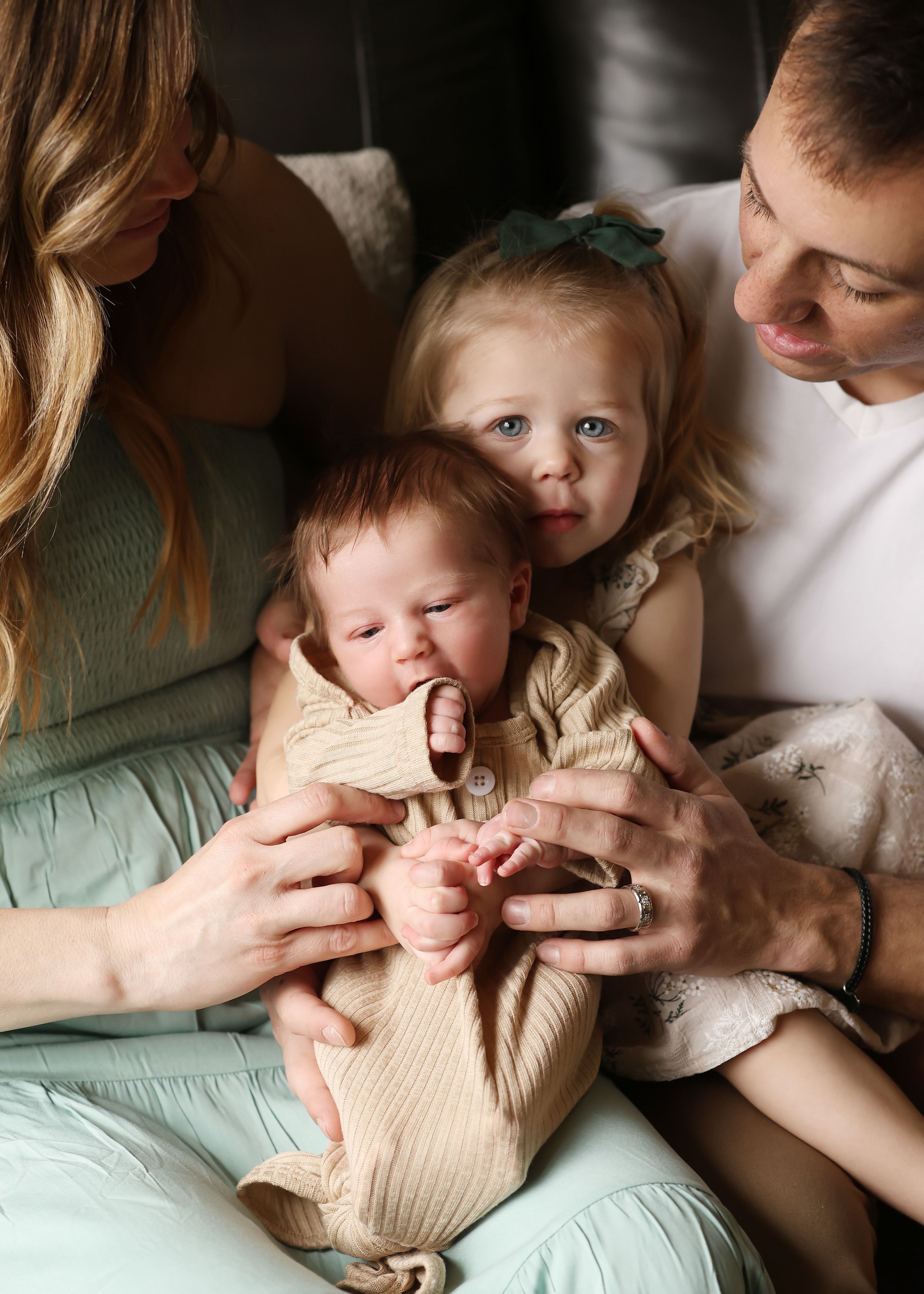 An intimate family moment captured in a series of casual indoor photos.