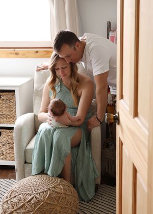 Intimate family moments captured in a series of tender photos with mint green decor and natural lighting.