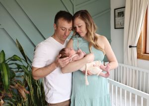 Family photos showing tender moments against a mint green wall and white furniture.