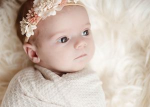 Series of delicate newborn portraits with pink floral headband against cream background.