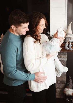 A couple in cozy sweaters share tender moments in their home.