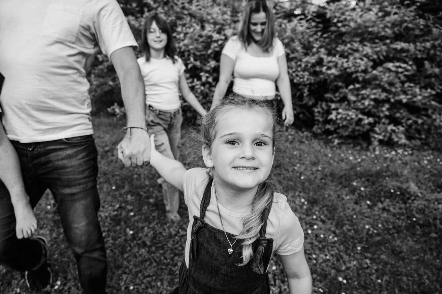 Black and white portrait of child playing outdoors.