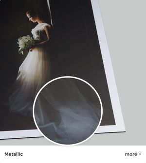 Bridal portrait in dramatic lighting showcasing metallic texture detail of dress skirt.
