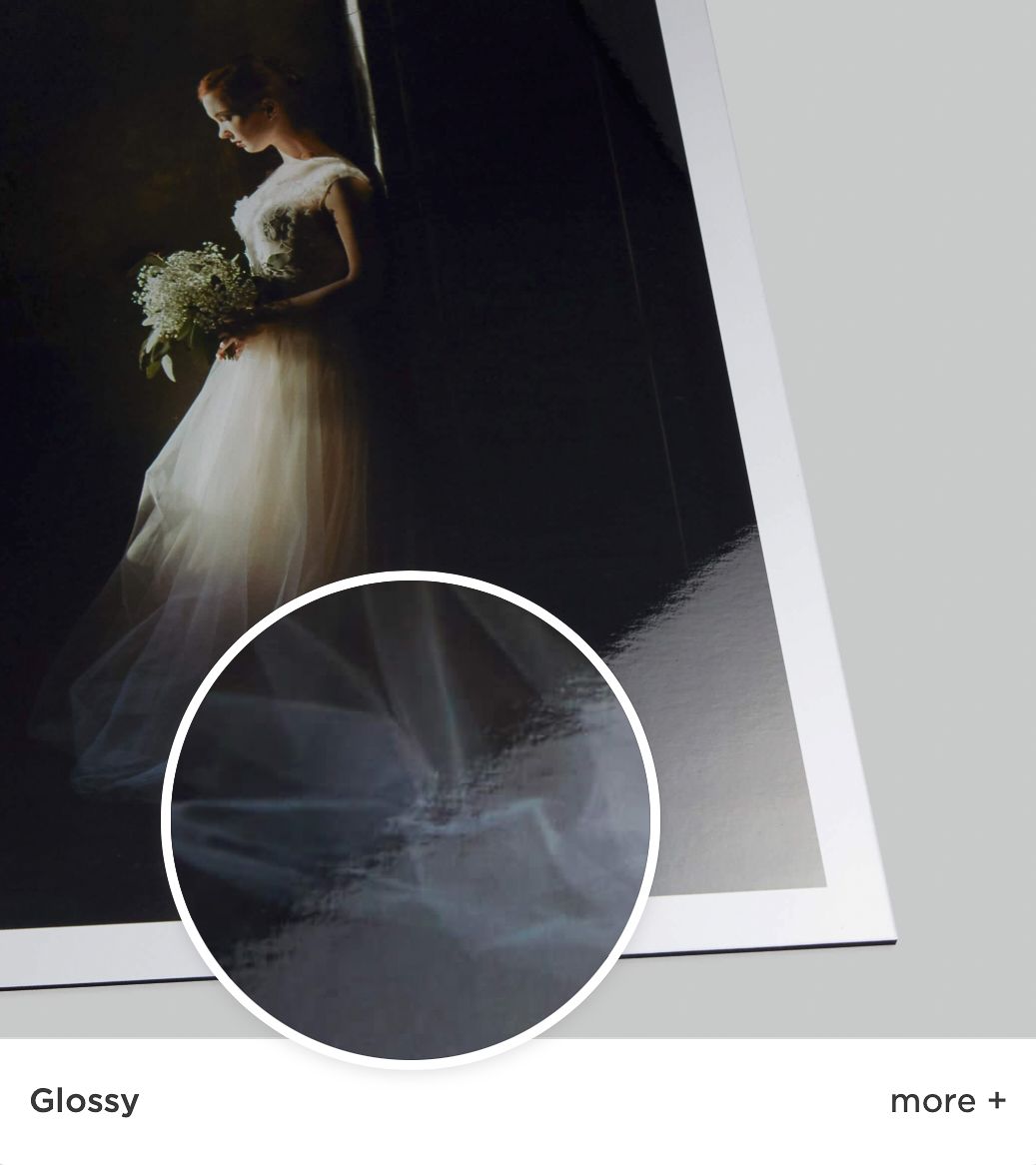 A wedding photograph showing a figure in a white gown holding a bouquet, with a glossy paper texture visible in closeup.