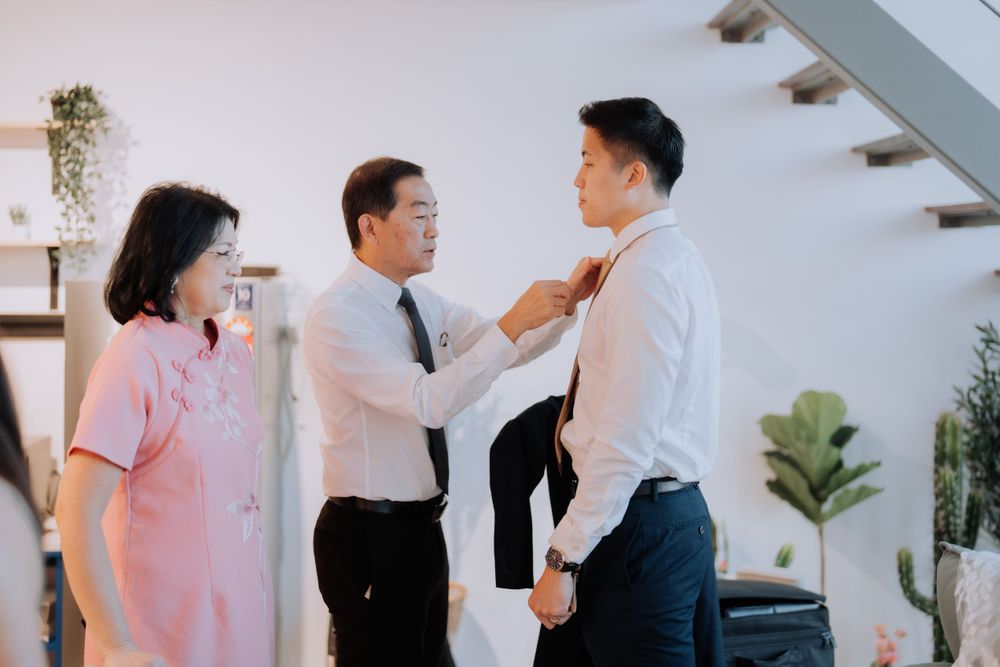 A family moment of getting dressed and ready before a formal occasion.