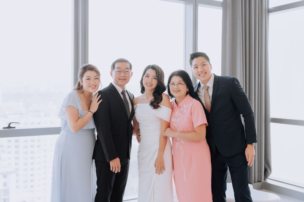 Family gathering in bright modern high-rise apartment with city views.