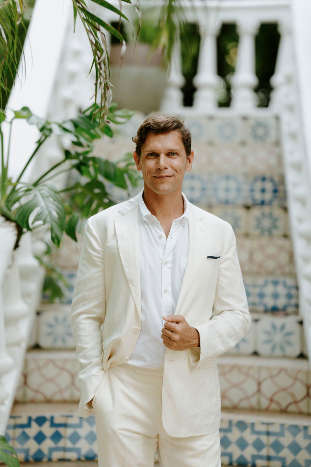 Groom waiting for the bride in lush garden setting, Nosara wedding photographer