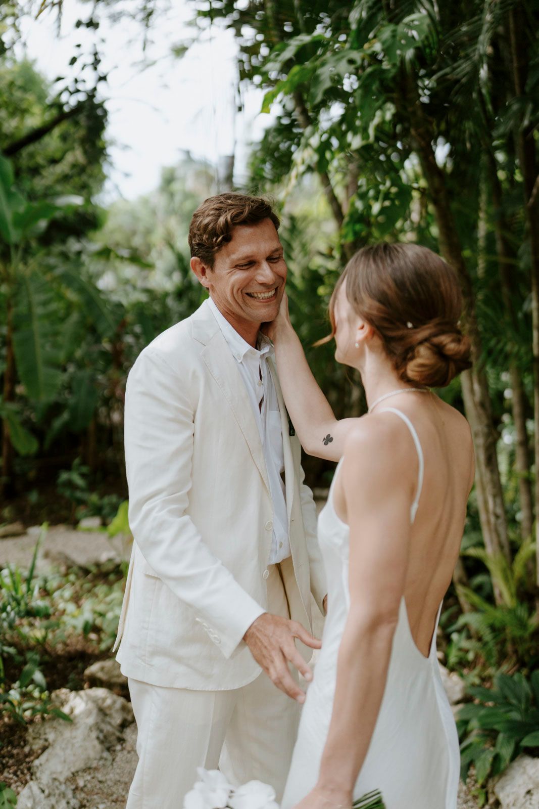 Bride and groom surrounded by tropical greenery in Nosara, Costa Rica
