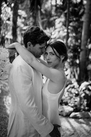 Black and white portrait of a wedding couple sharing an intimate moment in Nosara