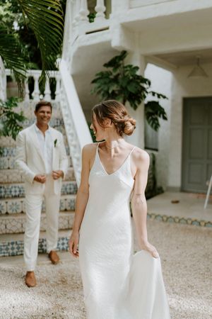 Bride and groom sharing their first look surrounded by tropical greenery in Nosara, Costa Rica