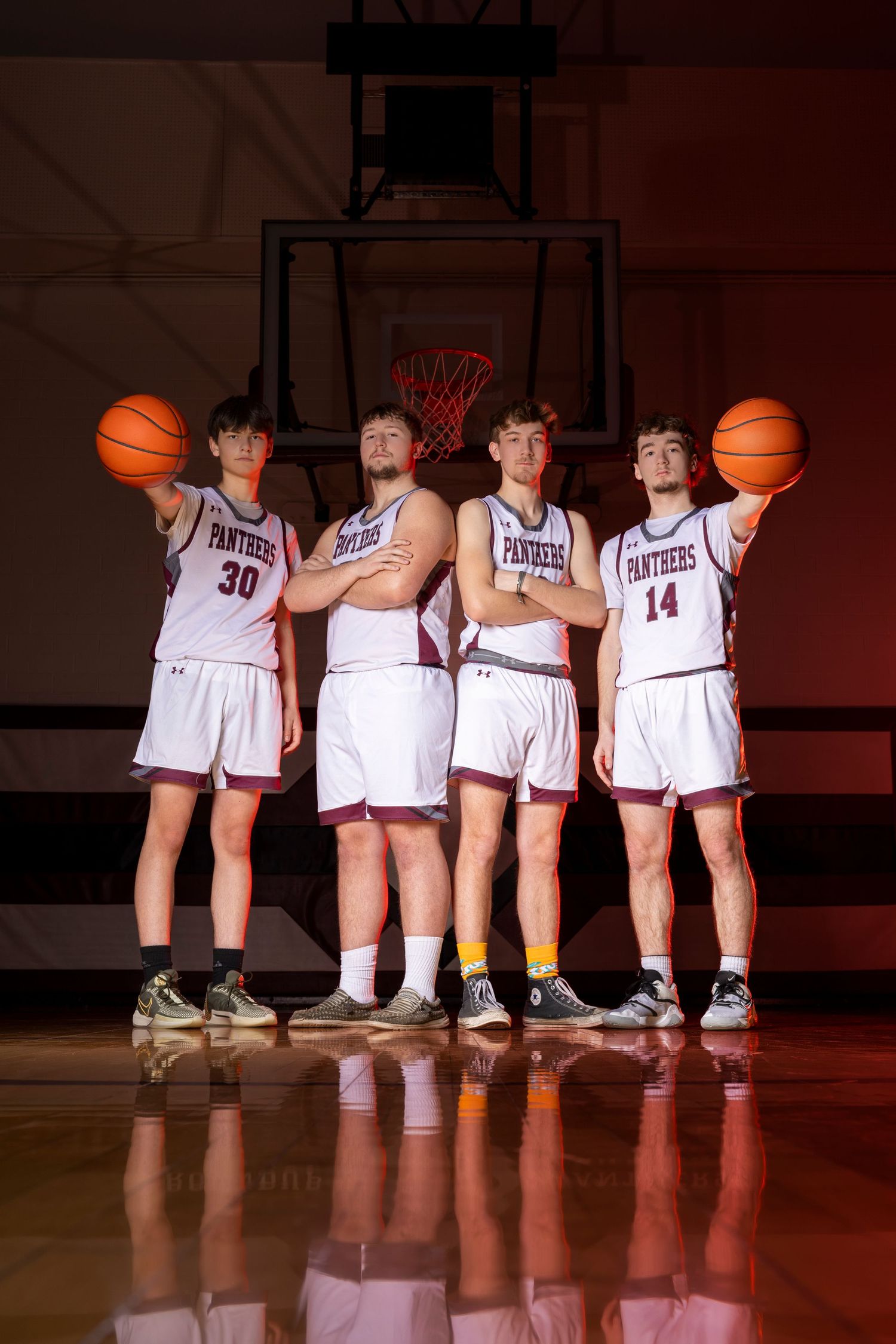 A small basketball group poses for a sharp, confident portrait session, showcasing unity and team pride with focused expressions.