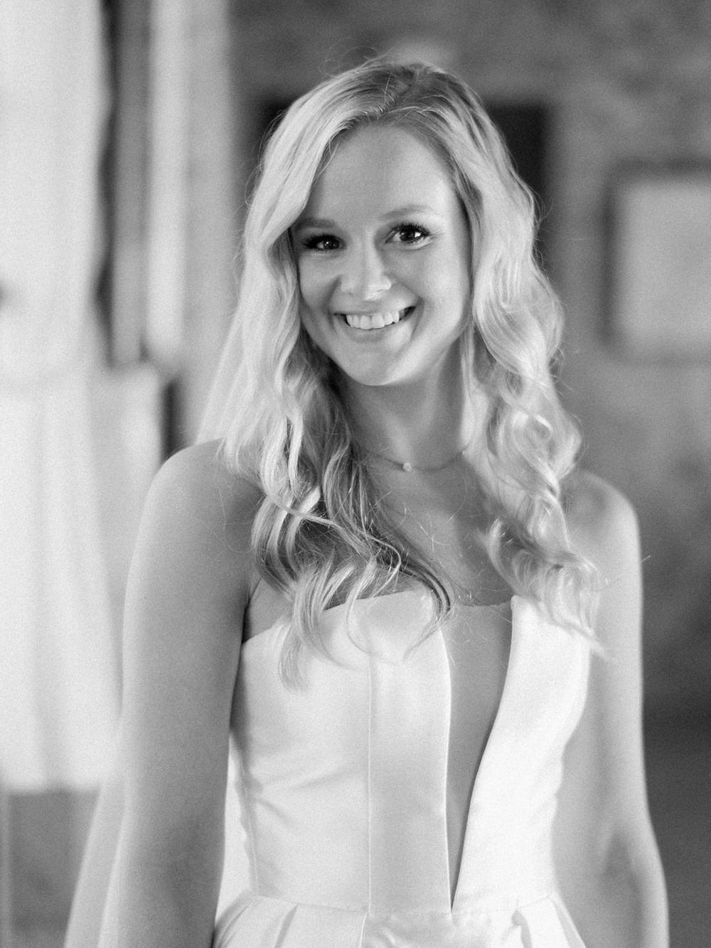 Portrait of a bride in a classic white wedding dress with plunging neckline.
