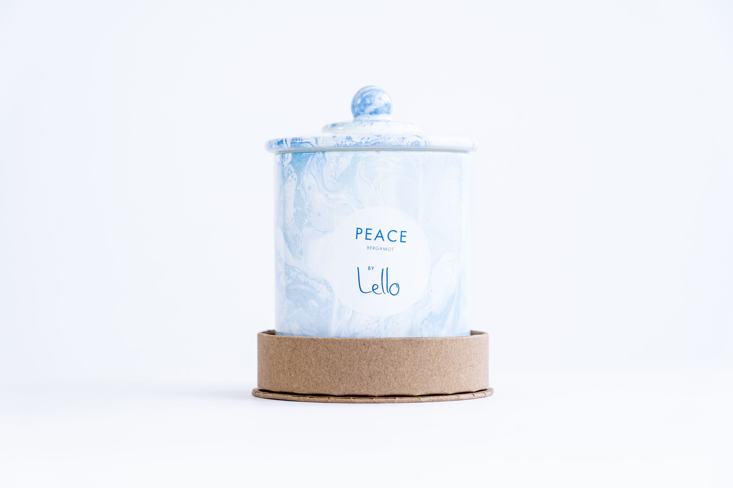 Light blue ceramic container labeled Peace with cork base on white background.