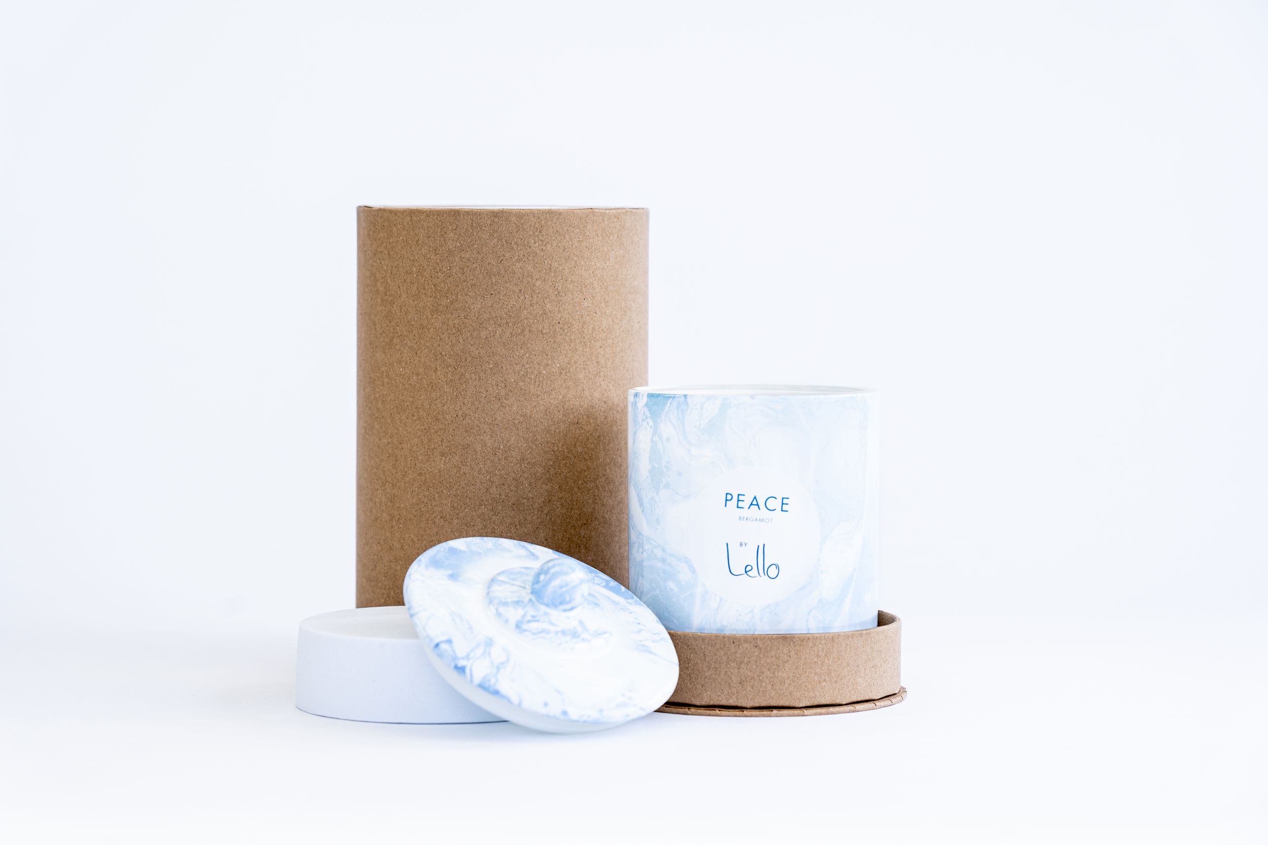 Minimalist packaging with blue and white containers on brown cylinder stand.