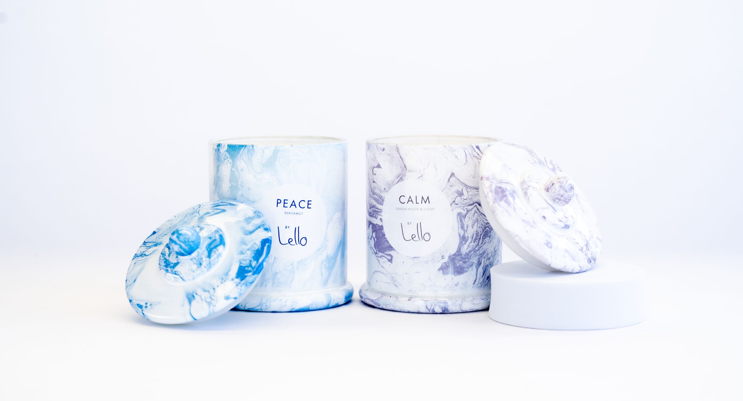Blue and white cylindrical containers with minimalist design displayed together on white background.