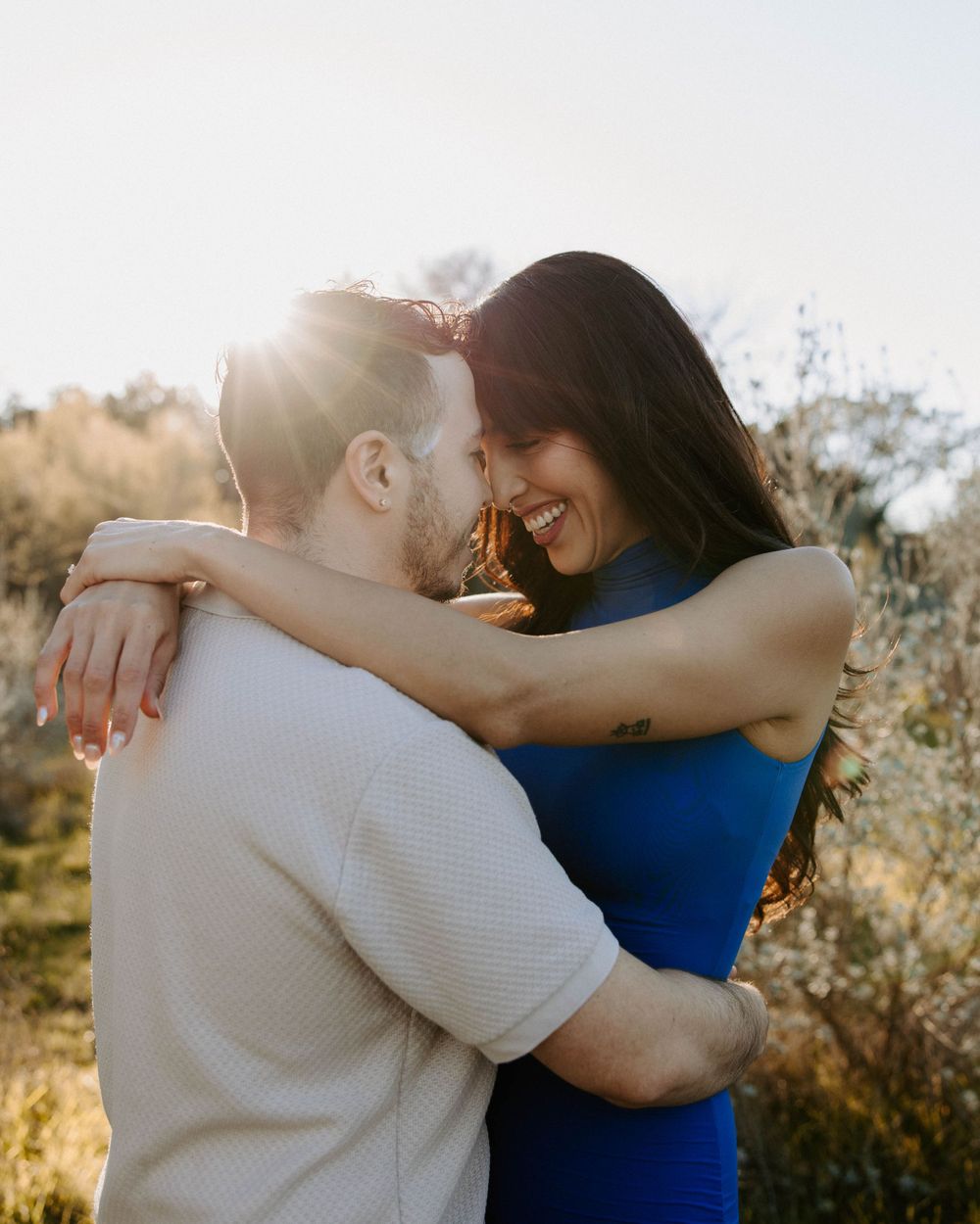 San Antonio Engagement Photography. Intimate sunset portrait of couple embracing in natural outdoor setting.