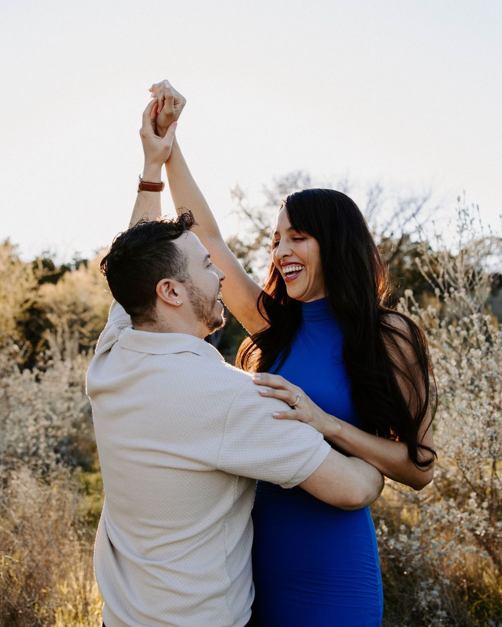 San Antonio Engagement Photography. Joyful couple dancing and laughing together in golden afternoon light.