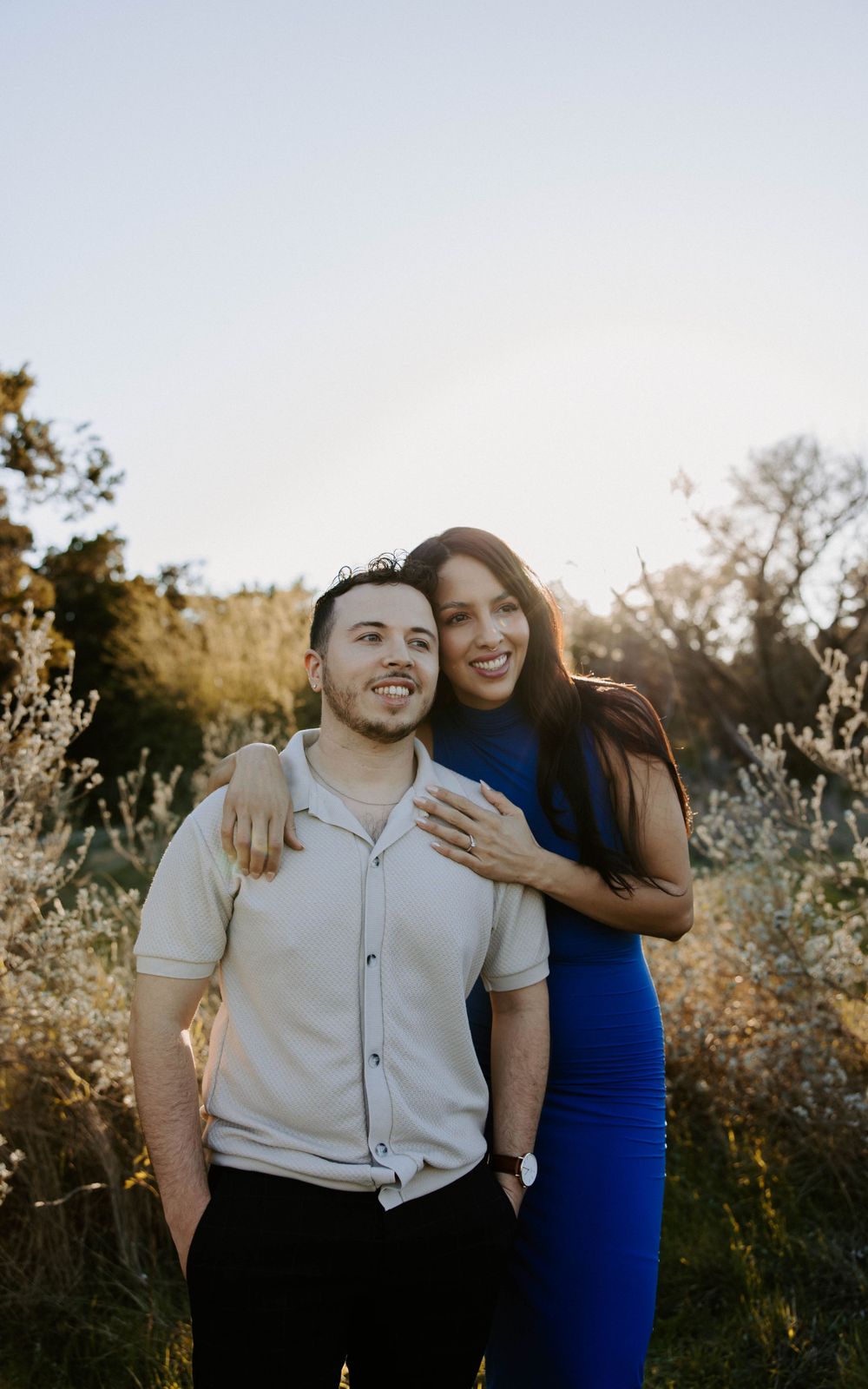 San Antonio Engagement Photography. Happy couple poses together in natural setting during golden hour photoshoot.
