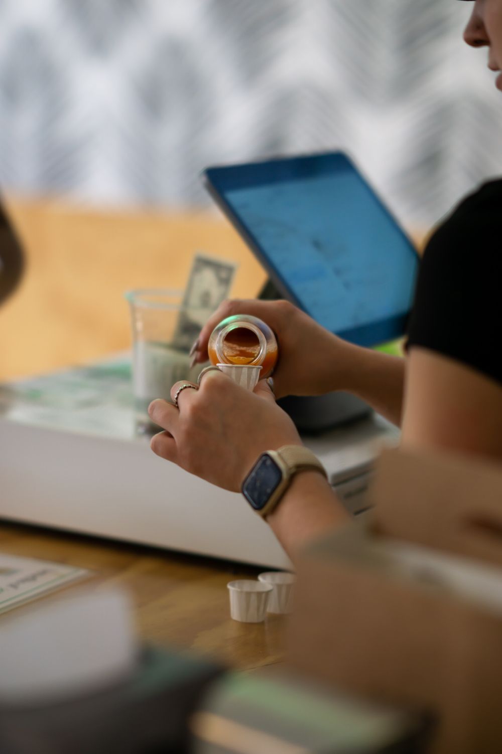 A close-up view of hands using digital devices and taking notes during a business meeting or study session.