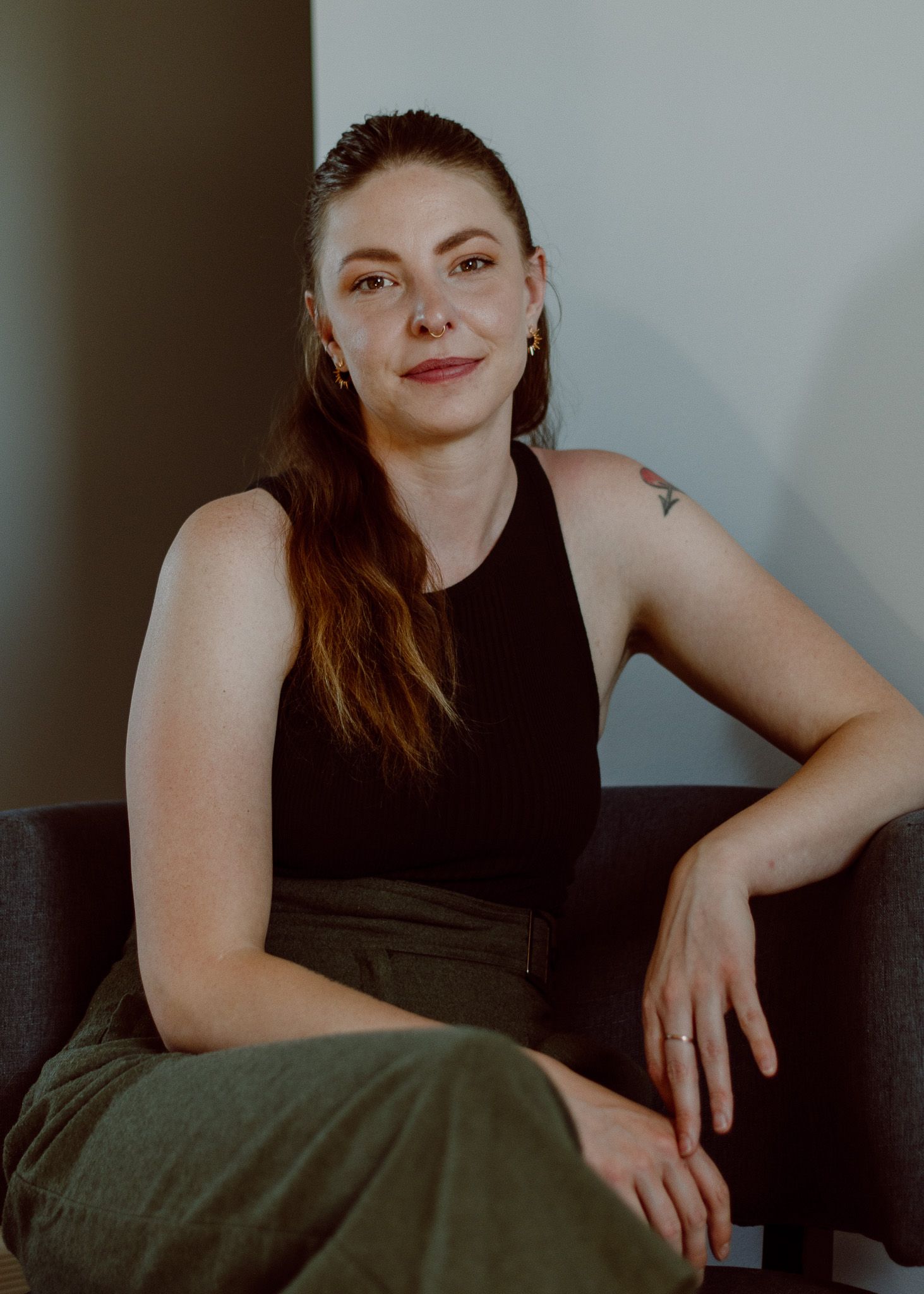 Headshot of a massage therapist with branding colors in green tones, conveying a calming and professional vibe.