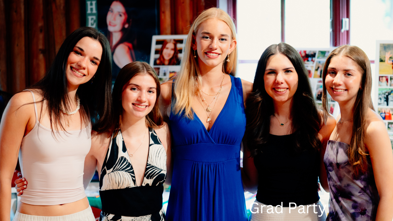 Group of friends gathered at a social event wearing colorful dresses and casual attire.