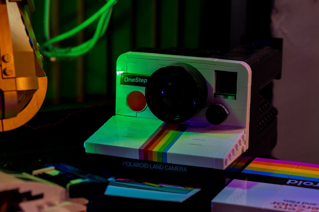 Colorful Polaroid OneStep camera lit with vivid neon in Mannyportraits Miami studio – cinematic detail capturing retro creative vibes.