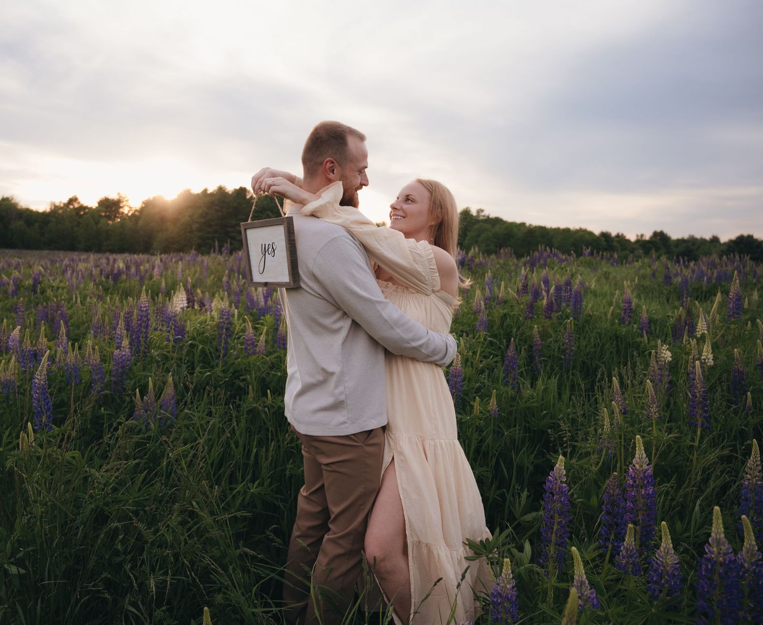 Sunset engagement session at a rustic outdoor location with picnic tables.