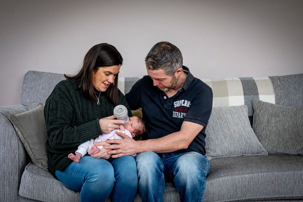eleanor barry photography newborn waterford munster baby asleep in mams arms sitting on couch