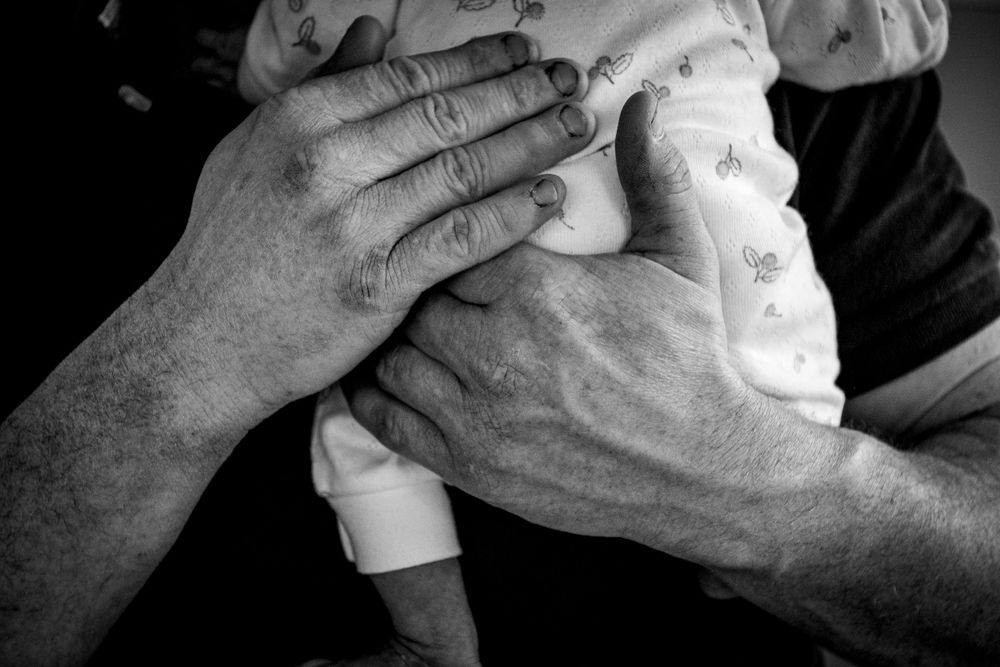 eleanor barry photography newborn waterford munster baby asleep in mams arms sitting on couch