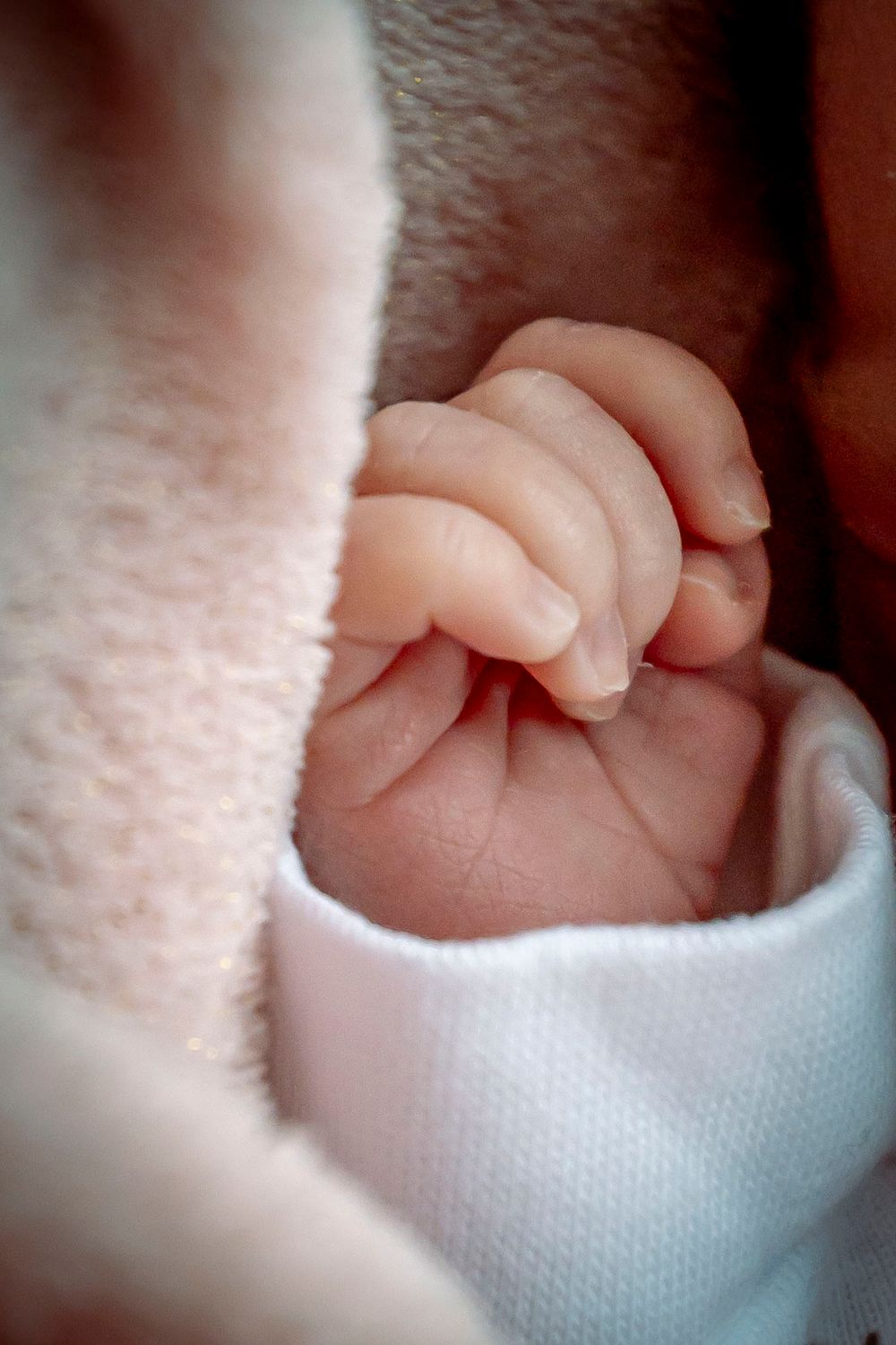 eleanor barry photography newborn waterford munster baby asleep in bouncer pink blanket close up of hand
