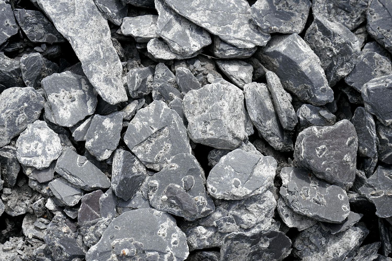 Pile of crushed gray stone or gravel aggregate material.