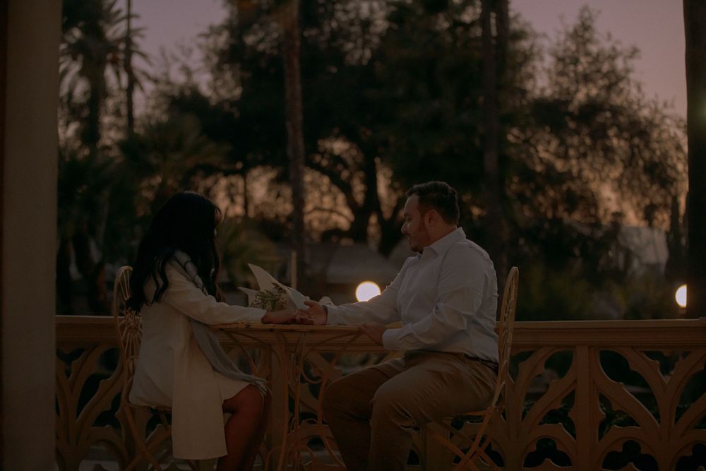 Cinematic photography of a couple enjoying some quiet time at a romantic table after they officially became engaged.