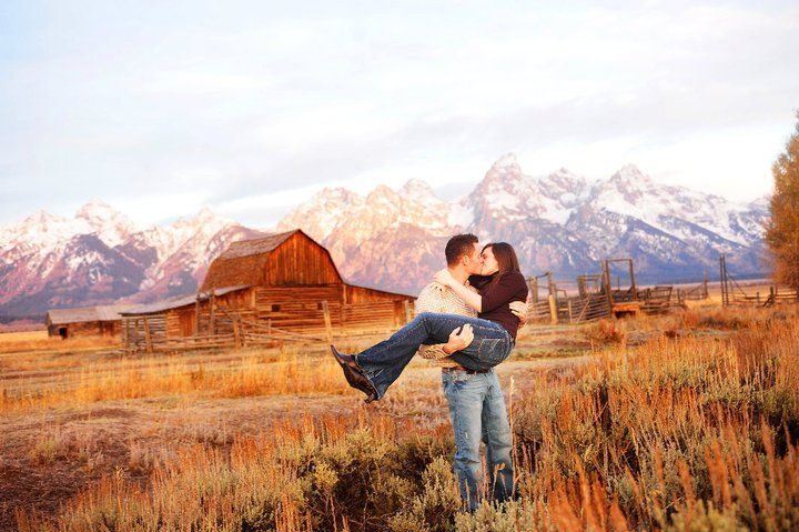 A romantic moment in front of the historic Moulton Barn with snow-capped Teton mountains towering in the background.