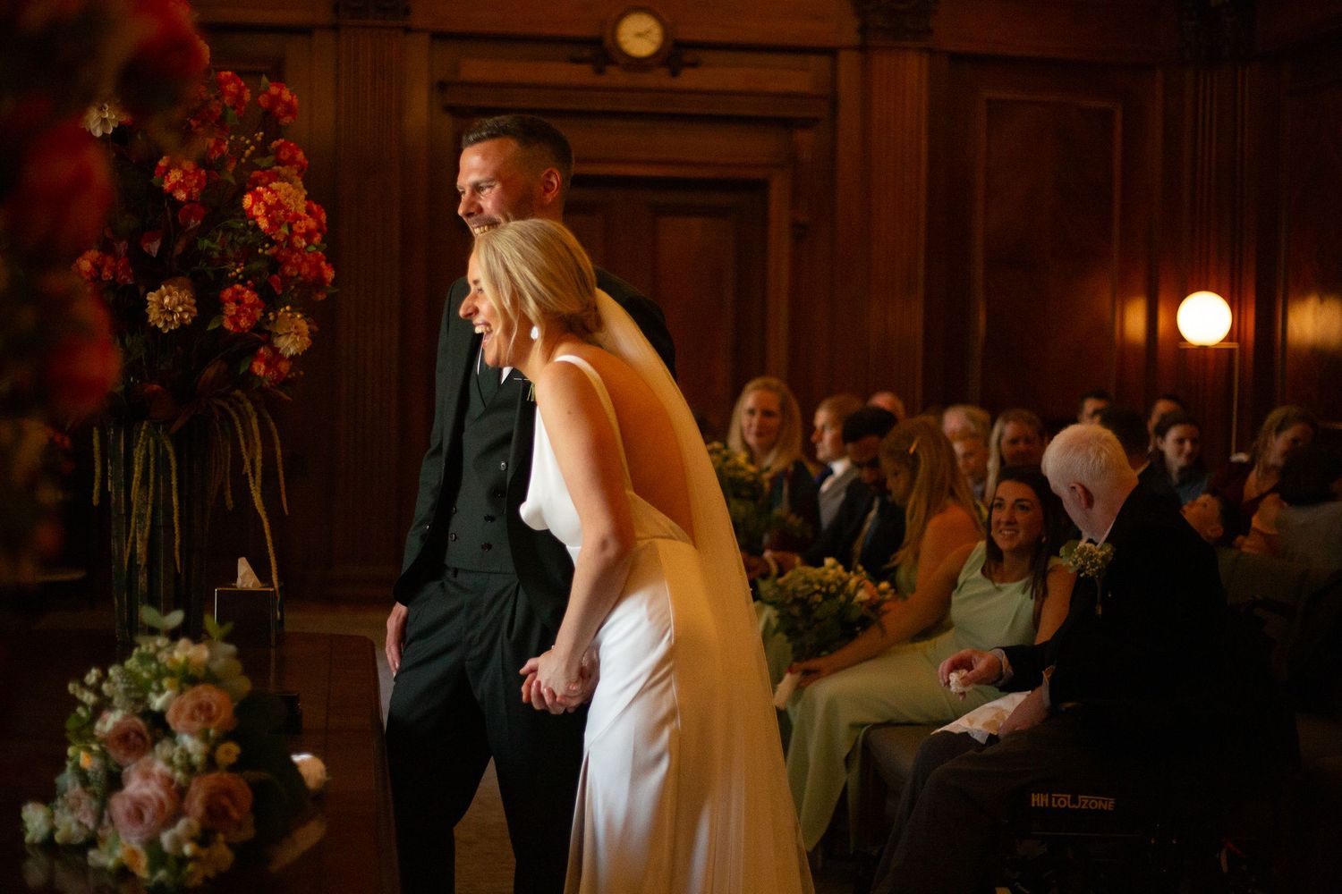 Bride and groom laughing during their vows at Old Marylebone Town Hall by Dominique Lauren Photography